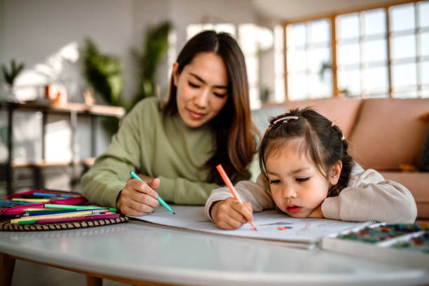 istock Mother and daughter drawing at home, having fun 1408770181