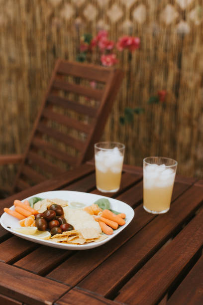 Snacks on dark wooden outdoor patio table