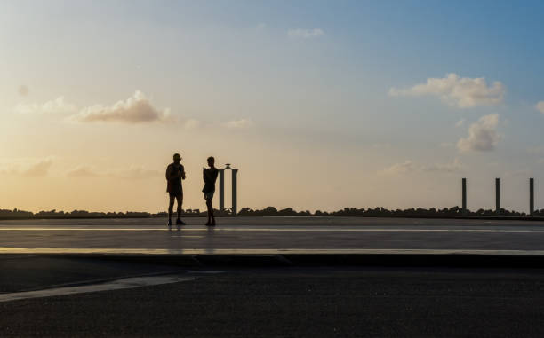 Recife, Pernambuco, Brazil - July 10, 2022:People walking in Marco Zero town square, Recife downtown with Sculpture Park in the background.