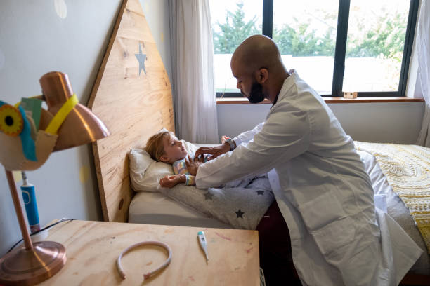 istock Doctor does a home visit to check on a sick young girl 1408797024