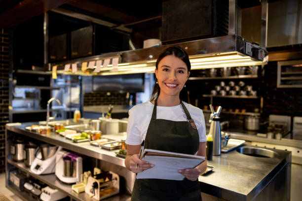 istock Happy waitress working at a restaurant and smiling 1408797949