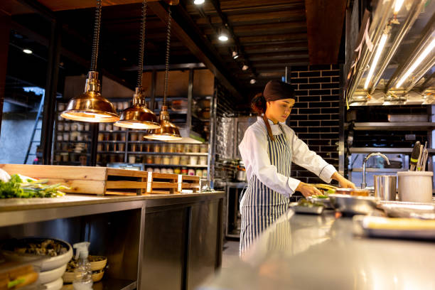 istock Cook working at a restaurant and cooking in the kitchen 1408797956