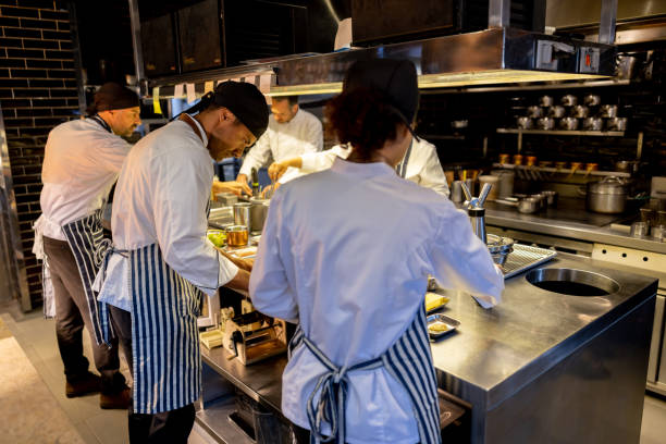 istock Group of chefs cooking together at a restaurant 1408797959