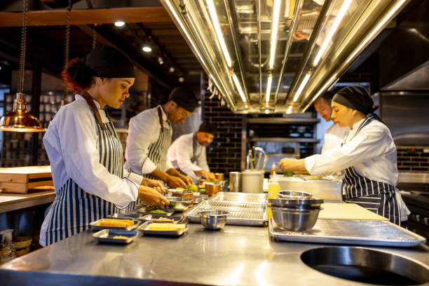 istock Group of chefs cooking together at a restaurant 1408797966