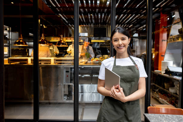 istock Portrait of a waitress working at a restaurant and smiling 1408797971
