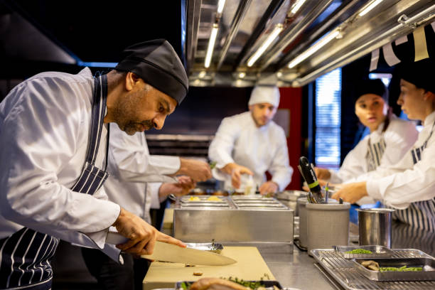 istock Chef working ar a restaurant preparing food and chopping some ingredient 1408797974