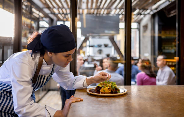 istock Chef decorating a plate in the kitchen at a restaurant 1408797980