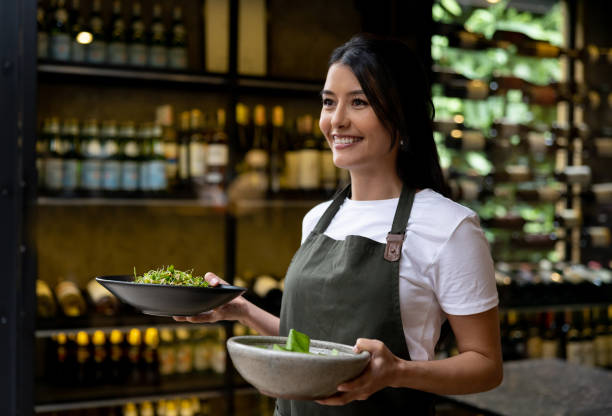 istock Happy waitress serving food at a restaurant 1408797981