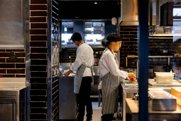 istock Cooks working at a restaurant and preparing food in the kitchen 1408797995