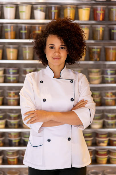 istock Successful female chef smiling at her restaurant 1408798000