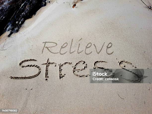 The Words Relieve Stress Are Written On Sandy Beach Stock Photo - Download Image Now
