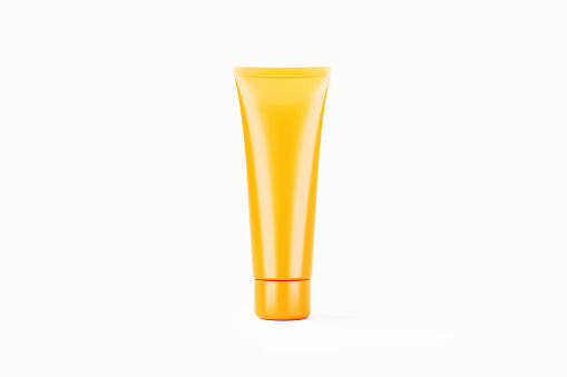 Blank yellow cosmetic tube sitting on white background. Horizontal composition with clipping path and copy space.