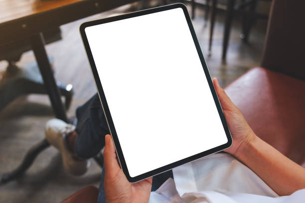 istock Mockup image of a woman holding digital tablet with blank white desktop screen 1408801863