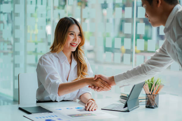 istock Two confident business people shaking hands during office meeting. Modern, greeting agreement concept. 1408802634