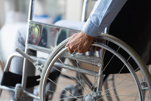 istock Businessman suffering from accident sickness in a wheelchair, sickness concept while working in the office. 1408802939