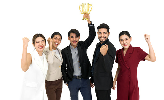 Team of successful young people standing together with trophy received from the work done proudly. Portrait on white background with studio light.