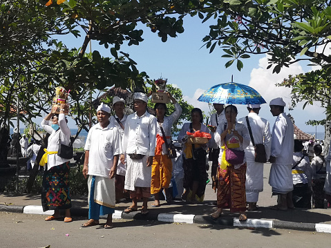 Locals during a Hindu celebration at Pura Goa Lawah, a Hindu temple in Klungkung, Bali, Indonesia. Pura Goa Lawah is noted for built around a cave opening which is inhabited by bats, hence its name, the Goa Lawah or 