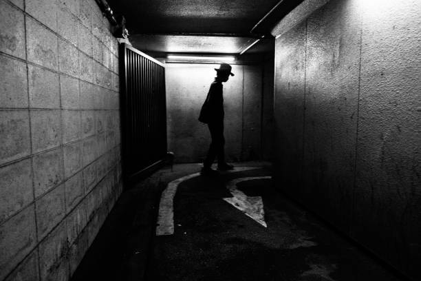 istock Silhouette of a man walking in a dark passage 1408810378