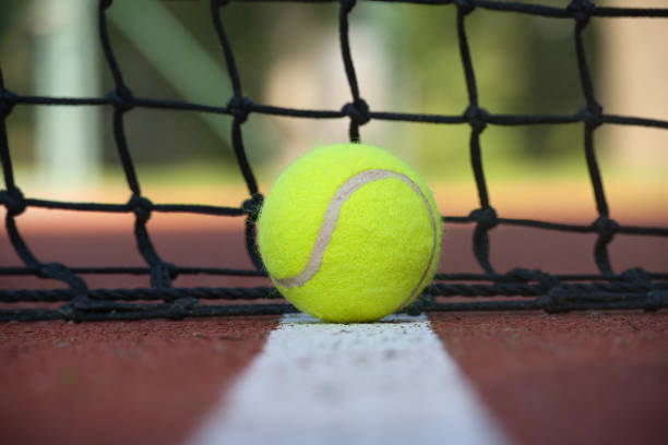 istock Tennis scene with black net, ball on white line 1408814329