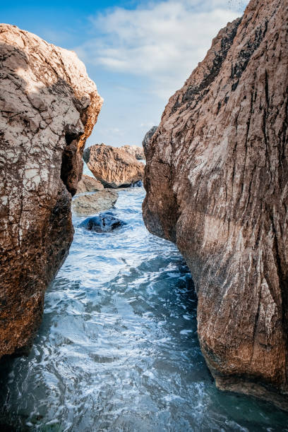istock Bizarre granite rock and azure bay 1408819070