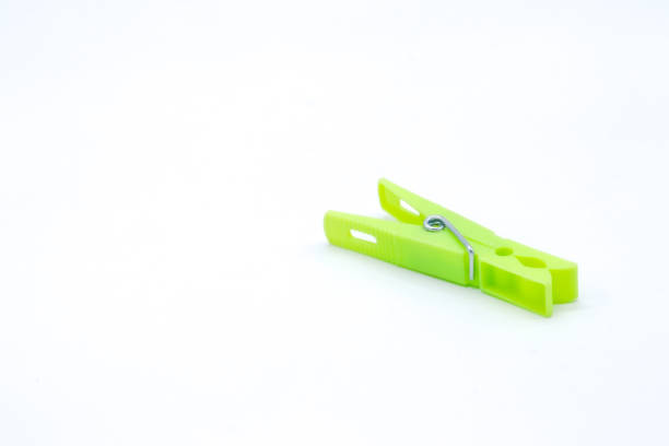 plastic clothespins with different colors like green, pink, blue, orange on white background