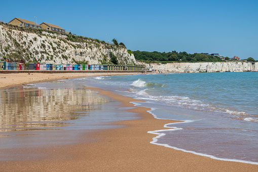 Stone Bay featuring sandy beach and white chalk cliff in the seaside town of Broadstairs, east Kent, England