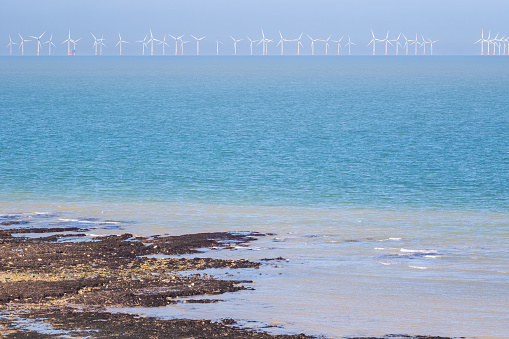 Floating offshore wind farms at horizon seen from Stone Bay in the seaside town of Broadstairs, east Kent, England