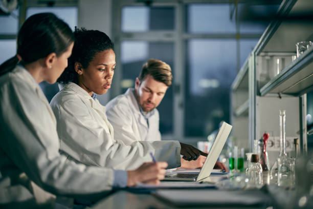 istock Students of science working on laptop in laboratory. 1408826321