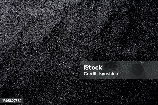 istock Black sand texture background 1408827560