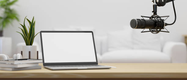 istock Modern broadcast or radio podcast home workspace with notebook laptop, microphone and copy space 1408831833