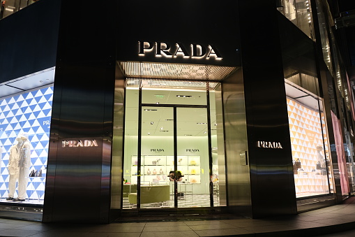 Shanghai,China-July 10th 2022: PRADA retail store front exterior at night. Luxury brand