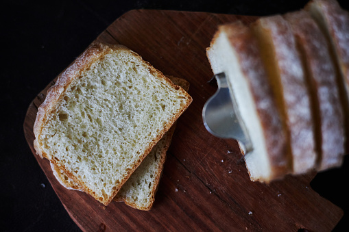 Preparing breakfast meal. Rye bread slice with butter and honey on white plate.