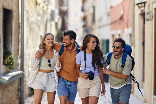 istock Cheerful tourists having fun while walking on the street. 1408836142