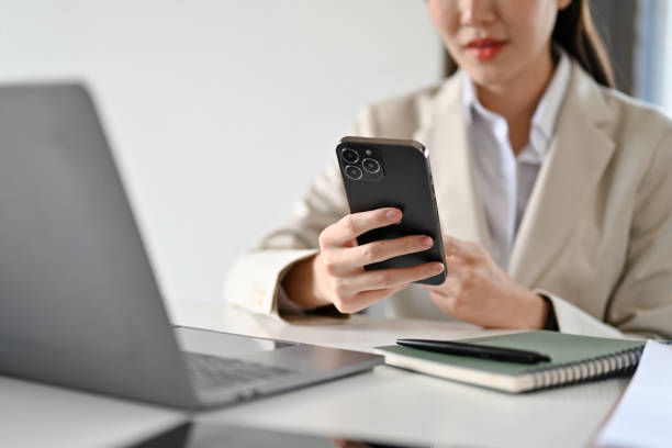 istock Asian female business manager using a smartphone to search some information on internet. 1408837795