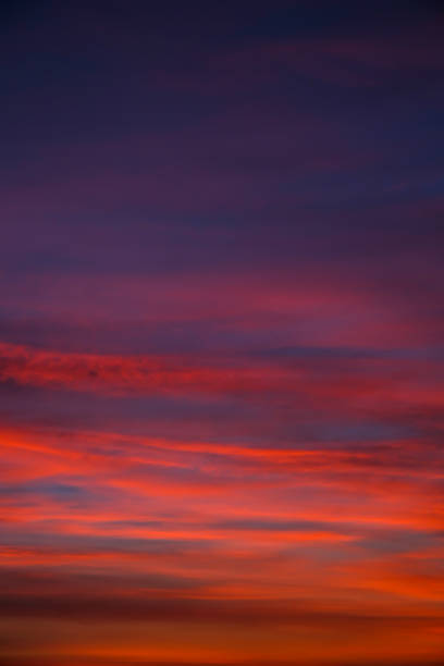 istock Vivid colourful clouds Dramatic Sky At Sunrise or Sunset. Orange red pink sky with beautiful clouds in sunlight background. Gradient cold to warm at sunset. Defocused abstract background 1408837863