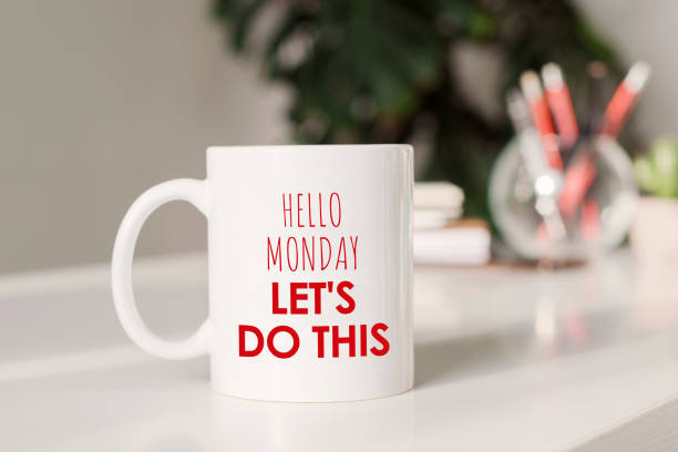 istock Coffee mug with text - Hello Monday, let's do this, in workplace background. 1408839041
