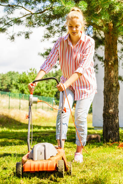 istock Gardening. Mowing lawn with lawnmower 1408839103