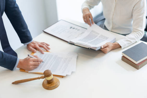 istock Midsection Of Lawyer With Client Working At Office 1408839216