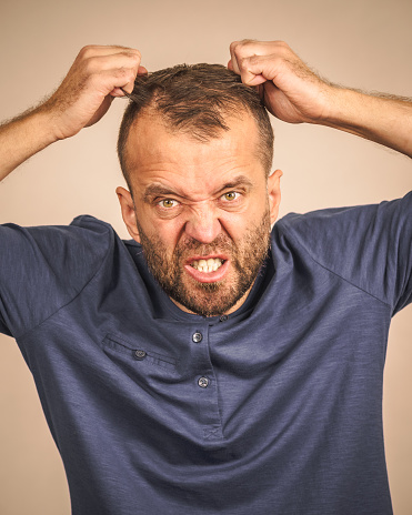 Furious bearded adult man, guy acting crazy being mad having mental crisis