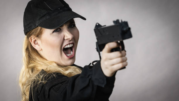 istock Woman holds gun in hands. 1408841598