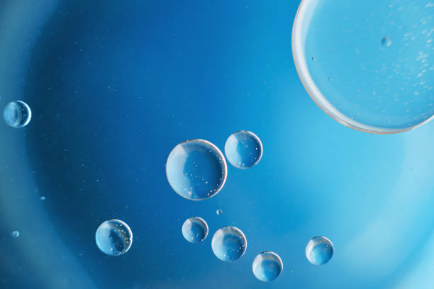 istock abstract light blue background with oil circles . bubbles of water close up . 1408841815