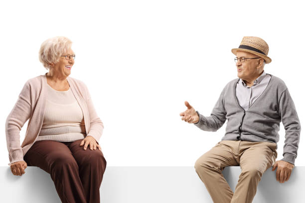 istock Senior man and woman sitting on a panel and having a conversation 1408842137