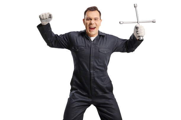 Excited auto mechanic holding a lug wrnech and gesturing happiness isolated on white background
