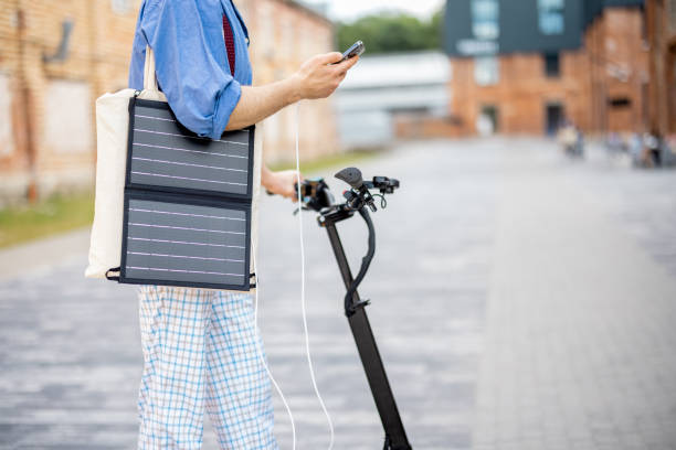 istock Stylish guy drives electric scooter and uses phone on the move 1408843719