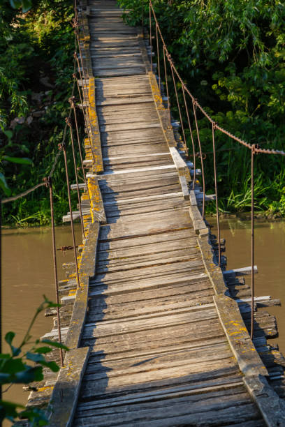 istock old suspension bridge over the river in the countryside going into perspective 1408844630