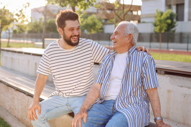 istock Happy senior man wsitting with son at park 1408844817