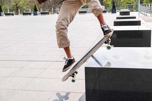 Professional skateboarder performing maneuver in the air on urban track.