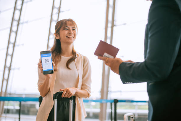 Asian young business woman using phone to check in stock photo