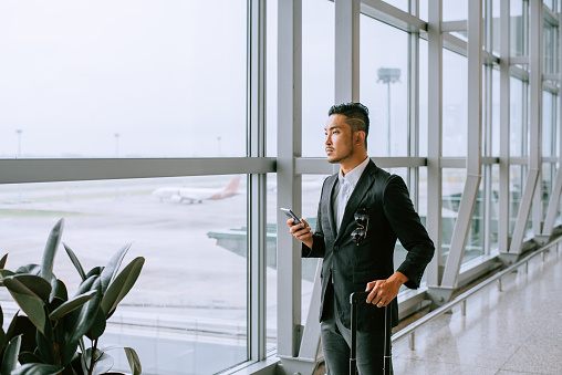 istock Asian businessman at the airport 1408846732