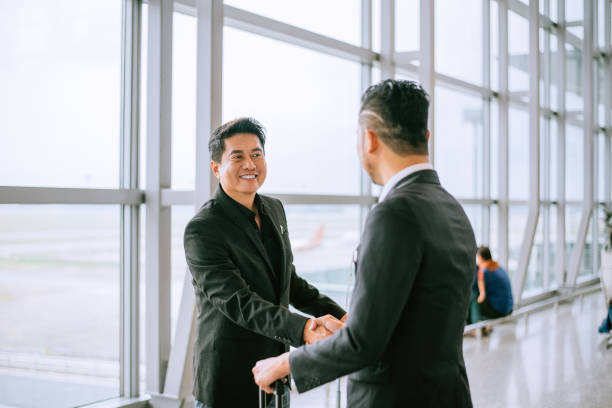 istock Business people shaking hands at airport 1408846898